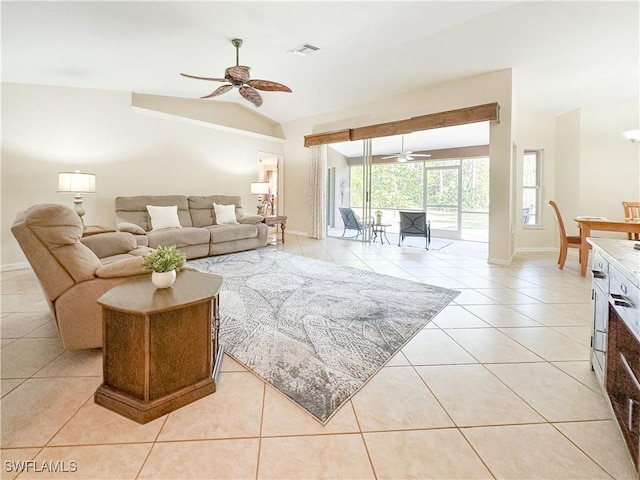 2910 2nd St NE, Naples, FL 34120 - living area featuring a ceiling fan, lofted ceiling, light tile patterned floors, and baseboards