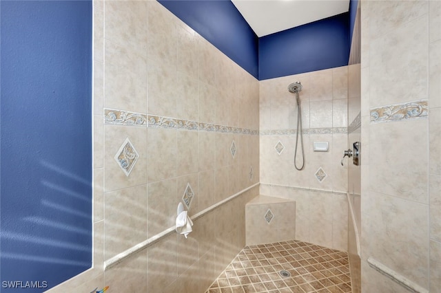 bathroom with a tile shower