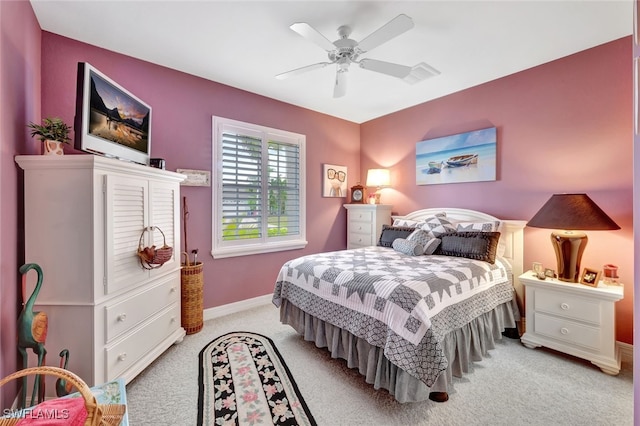 bedroom featuring ceiling fan, baseboards, and light colored carpet