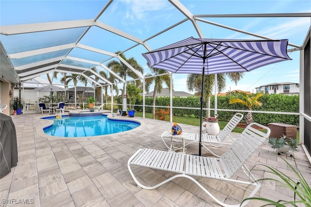 view of swimming pool featuring a patio area and a lanai