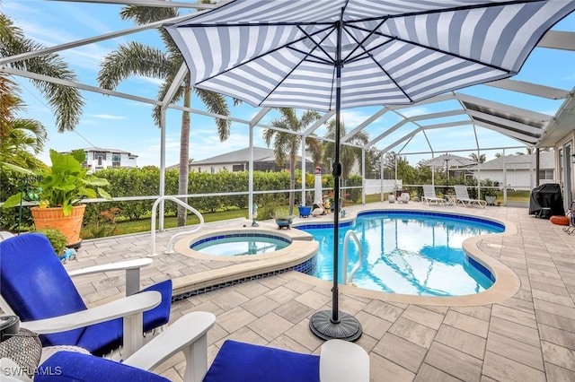 view of swimming pool featuring glass enclosure, a patio area, and an in ground hot tub