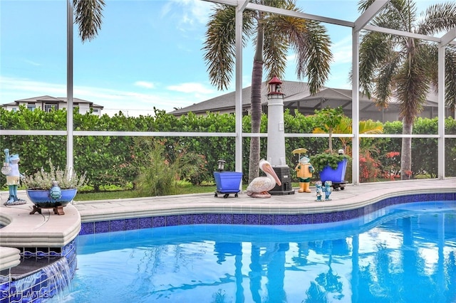 view of swimming pool featuring glass enclosure and pool water feature