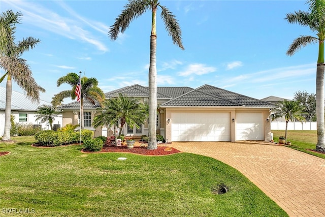 view of front facade featuring a garage, stucco siding, decorative driveway, and a front yard