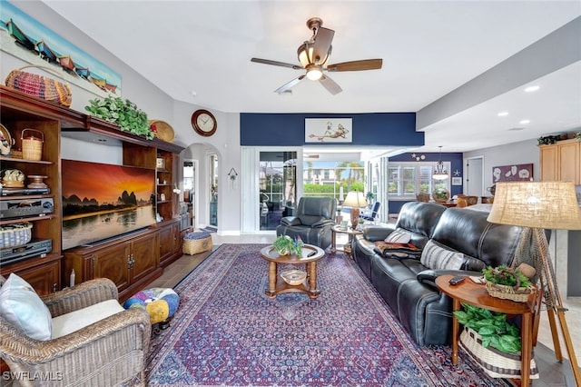 living room with arched walkways, ceiling fan, and recessed lighting