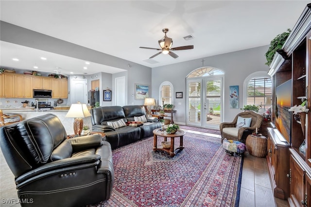 living area with ceiling fan, visible vents, french doors, and recessed lighting