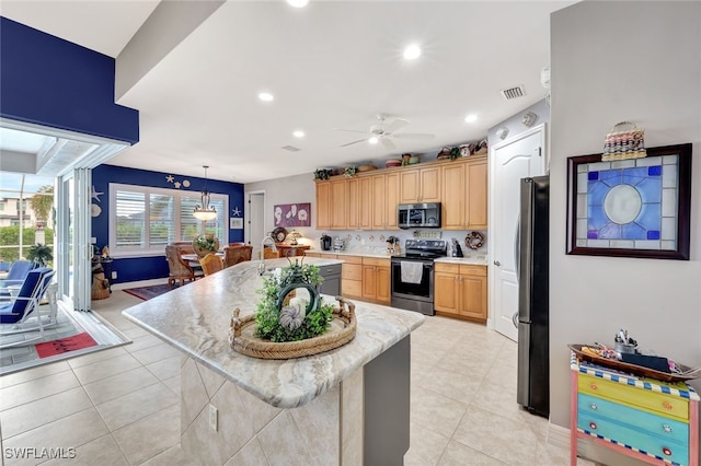 kitchen with pendant lighting, a kitchen island, stainless steel appliances, light tile patterned flooring, and a breakfast bar