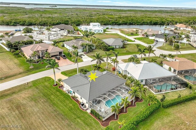 drone / aerial view featuring a water view and a residential view