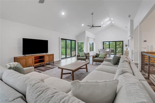 living room featuring ceiling fan, wood-type flooring, and high vaulted ceiling