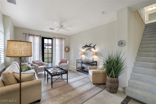 living room with ceiling fan and tile patterned floors