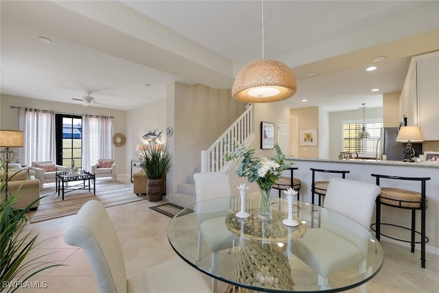 tiled dining area featuring plenty of natural light and ceiling fan