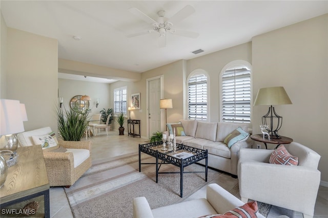 living room with ceiling fan, a healthy amount of sunlight, and light tile patterned floors