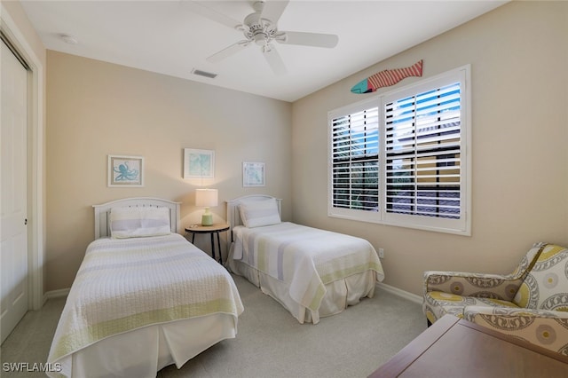 bedroom with a closet, ceiling fan, and carpet