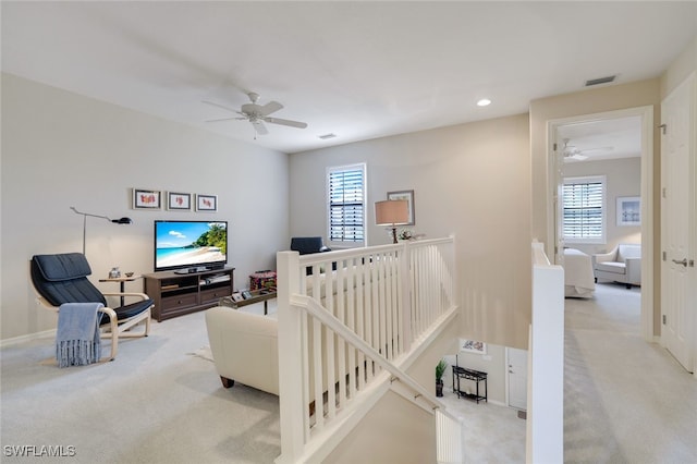 carpeted living room featuring a healthy amount of sunlight and ceiling fan