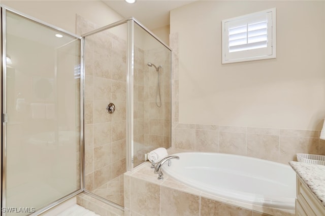 bathroom with vanity and independent shower and bath