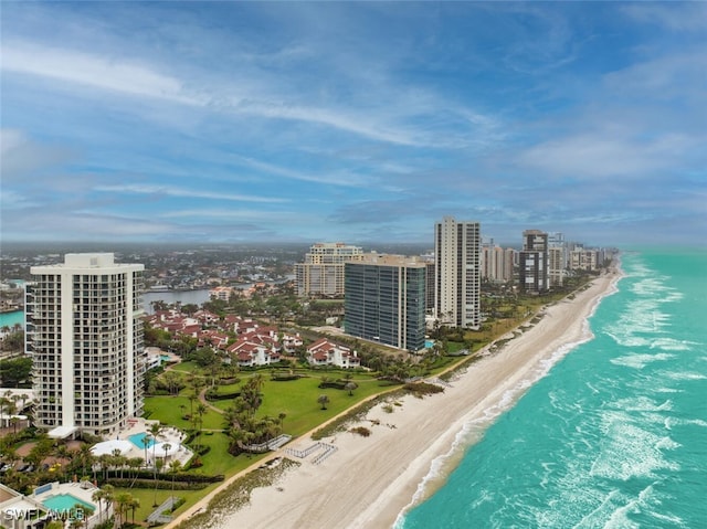 drone / aerial view featuring a water view and a beach view