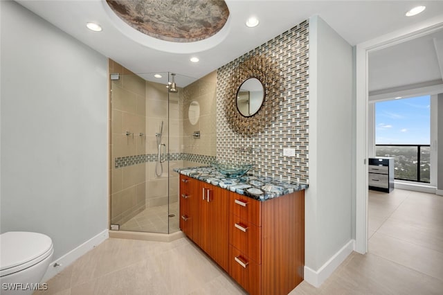 bathroom featuring walk in shower, toilet, vanity, tile patterned flooring, and backsplash