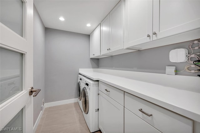 washroom with cabinets, light tile patterned floors, and independent washer and dryer