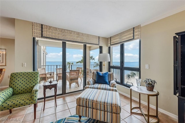 living area featuring light tile patterned floors, a wealth of natural light, and a water view