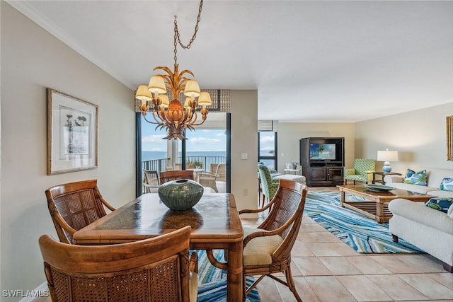 dining space with crown molding, a water view, light tile patterned floors, and an inviting chandelier