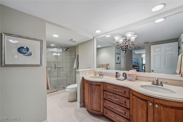 bathroom featuring a chandelier, tile patterned flooring, vanity, toilet, and a shower with door