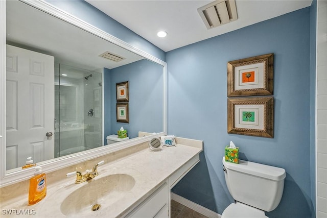 bathroom with tile patterned flooring, vanity, an enclosed shower, and toilet