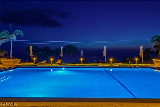 view of pool at night