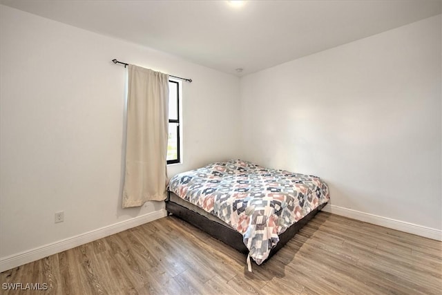 bedroom featuring wood-type flooring