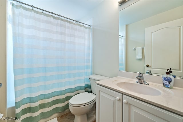 bathroom with vanity, tile patterned floors, and toilet