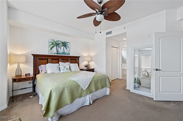 carpeted bedroom featuring connected bathroom, a closet, and ceiling fan