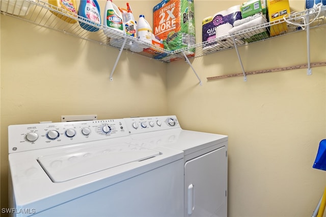 laundry room featuring washing machine and clothes dryer