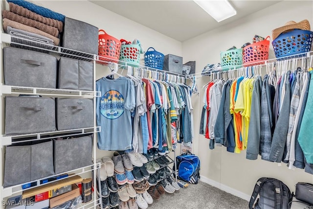 walk in closet with carpet flooring