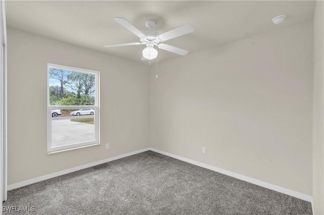 unfurnished room with ceiling fan and carpet flooring