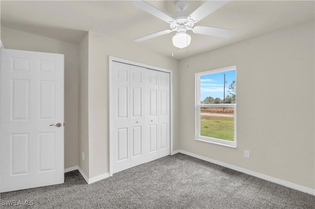 unfurnished bedroom with carpet flooring, ceiling fan, and a closet