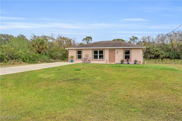 single story home featuring a front lawn