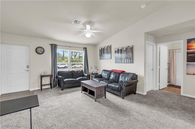 living room with ceiling fan, lofted ceiling, and light carpet