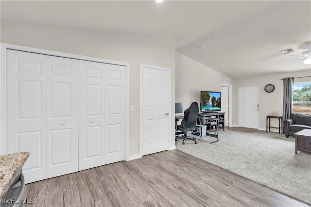 office space with lofted ceiling and light hardwood / wood-style flooring