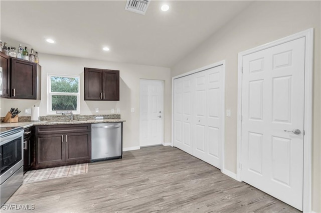 kitchen with stainless steel appliances, sink, dark brown cabinetry, and light wood-type flooring