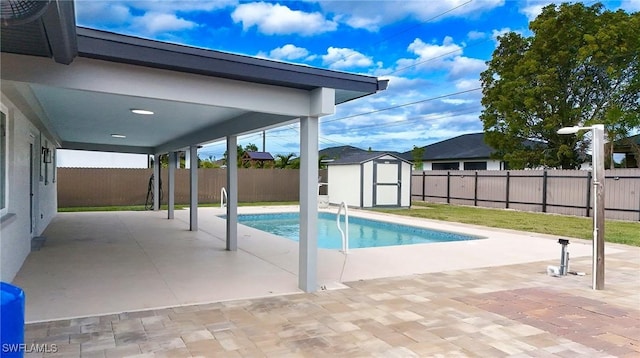 view of pool featuring a patio area and a shed