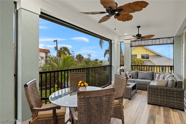 sunroom / solarium featuring ceiling fan