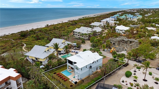 bird's eye view featuring a view of the beach and a water view