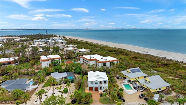 birds eye view of property featuring a beach view and a water view