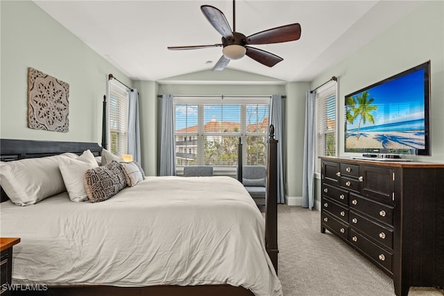 carpeted bedroom featuring ceiling fan and vaulted ceiling