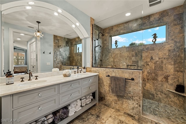 bathroom featuring vanity and tiled shower