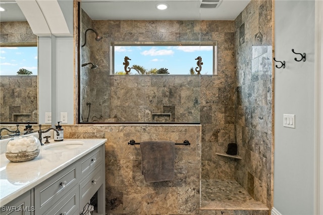 bathroom featuring vanity and a tile shower