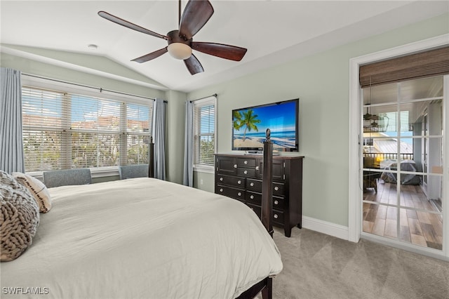 bedroom featuring lofted ceiling, light colored carpet, and ceiling fan