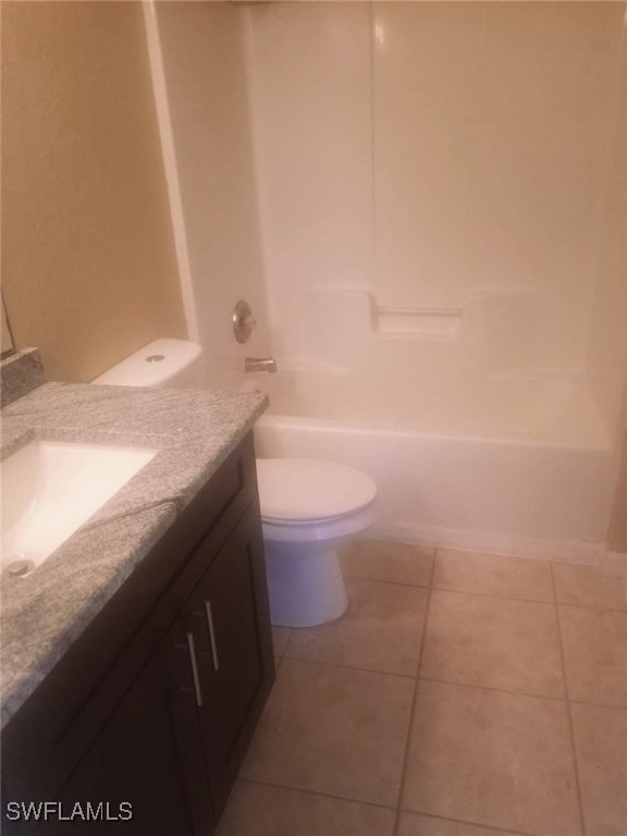 full bathroom with tile patterned flooring, vanity, shower / bathtub combination, and toilet