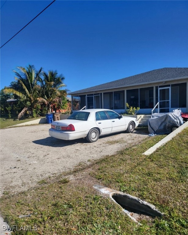 view of front of property featuring a sunroom