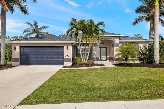 view of front of home featuring a garage and a front lawn