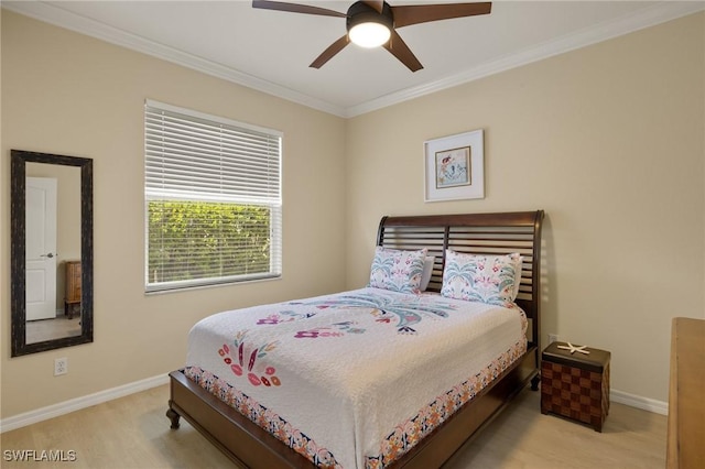 bedroom featuring crown molding, light hardwood / wood-style floors, and ceiling fan