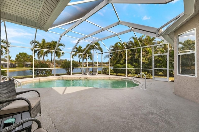 view of pool with a water view, a patio, and glass enclosure